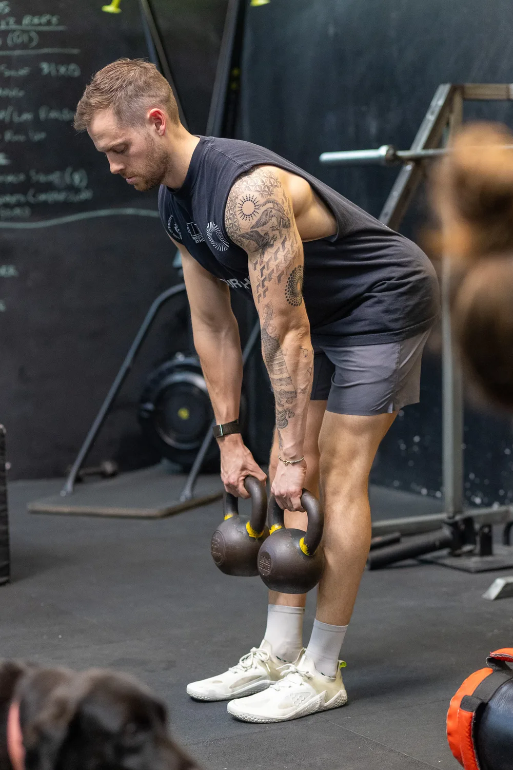 Wade demonstrating a kettlebell hinge during a strength workshop